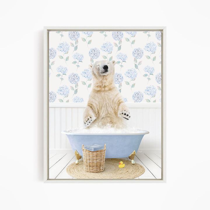 A polar bear is sitting in a blue bathtub filled with water, surrounded by a wicker basket and a yellow rubber duck.