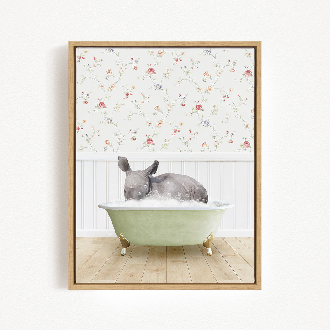 A gray rhinoceros is sitting in a green bathtub filled with water, surrounded by a floral wallpaper.