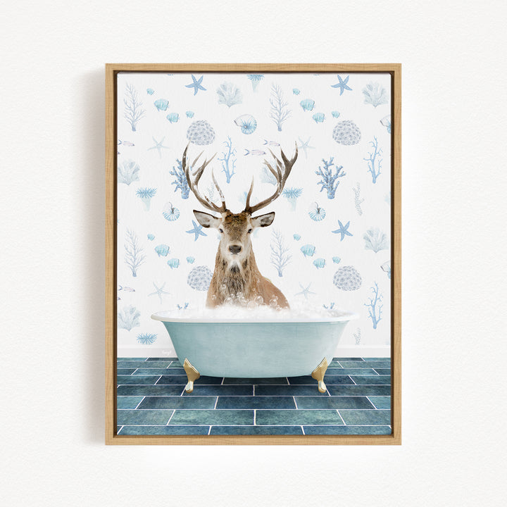 A deer with antlers is sitting in a bathtub filled with bubbles, surrounded by a blue and white patterned wall.