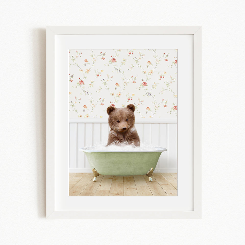 A brown bear sitting in a green bathtub filled with water, with a floral wallpaper in the background.