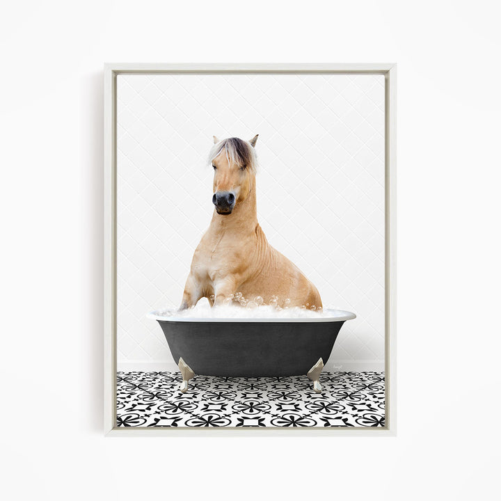 A light brown horse is sitting in a black bathtub filled with water, surrounded by a black and white patterned floor.