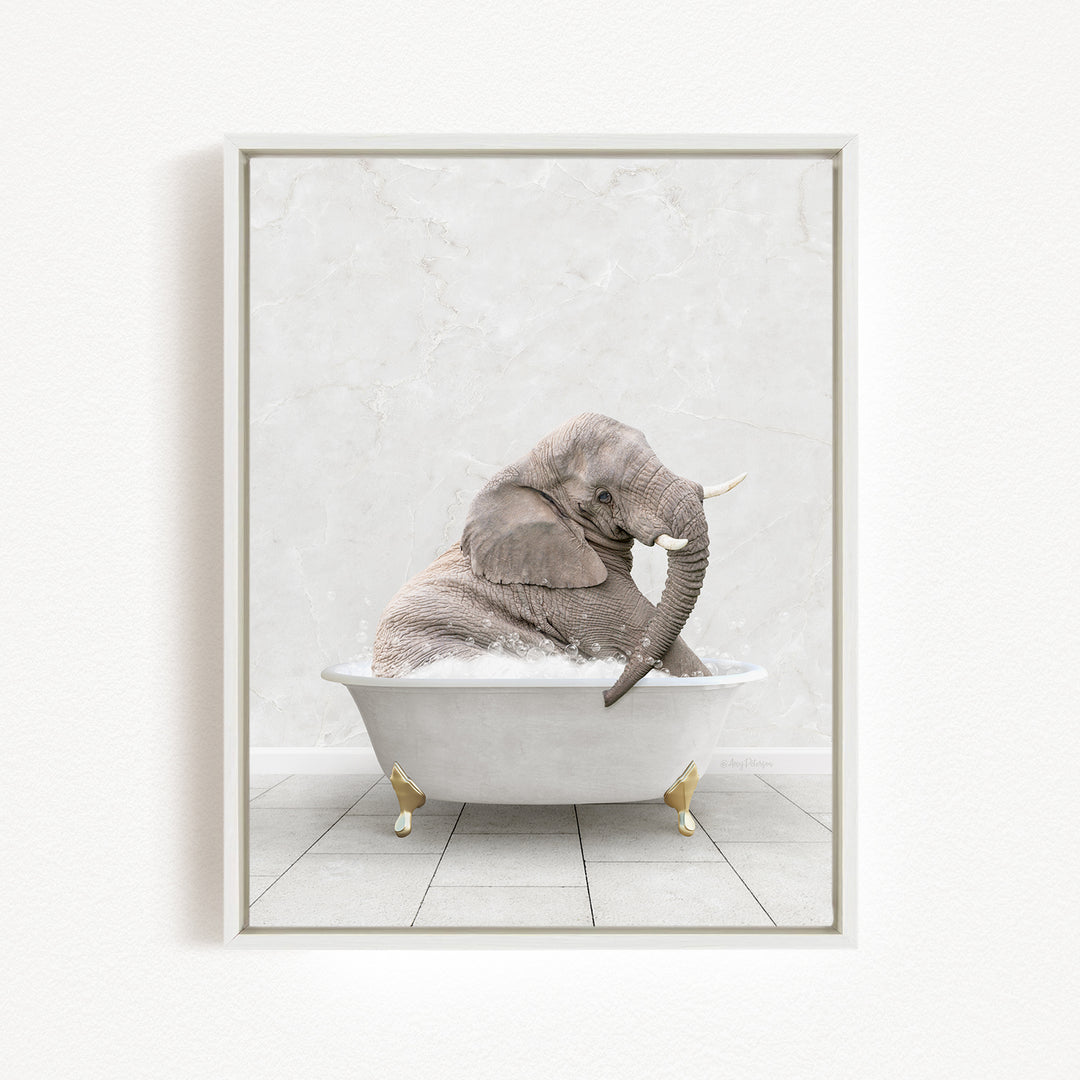 A gray elephant sitting in a white bathtub, with its trunk raised and appearing to be enjoying the bath.