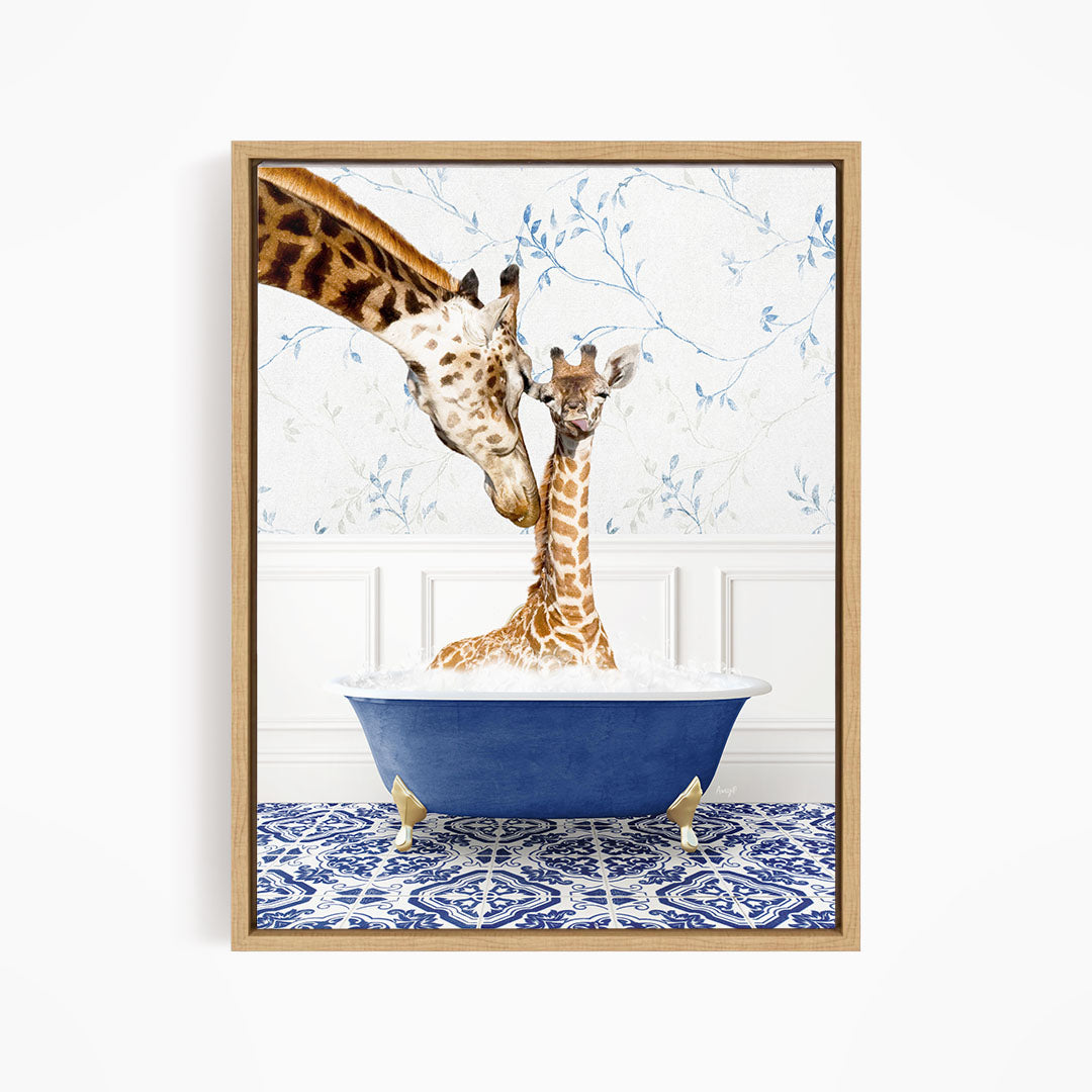 A mother giraffe and her baby giraffe are sitting together in a blue bathtub, with the mother gently nuzzling her baby.