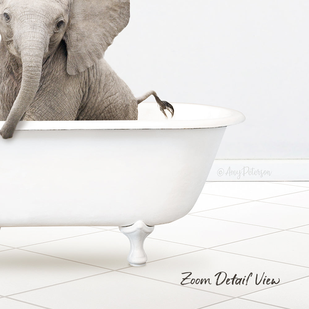 A gray elephant sitting in a white bathtub, with its trunk in the water.