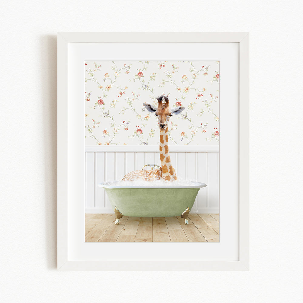 A giraffe sitting in a green bathtub filled with bubbles, surrounded by a floral wallpaper.