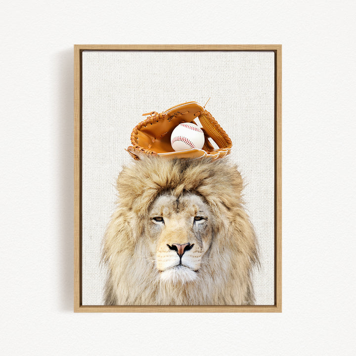 A framed image of a lion wearing a baseball glove on its head, with a baseball resting on top of the glove.