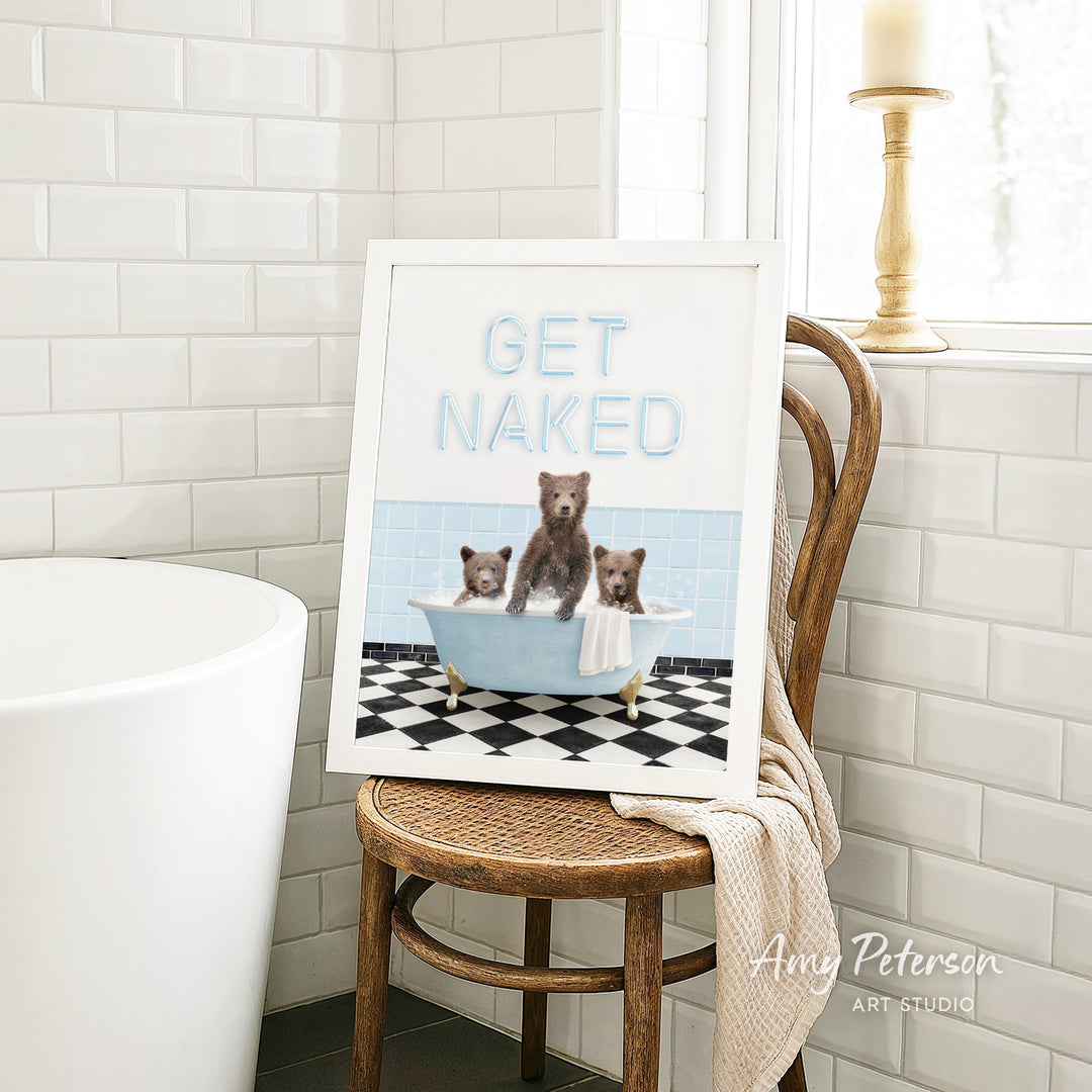 A framed print featuring a bear sitting in a bathtub with two other bears, accompanied by the text "GET NAKED" in a playful, humorous manner.
