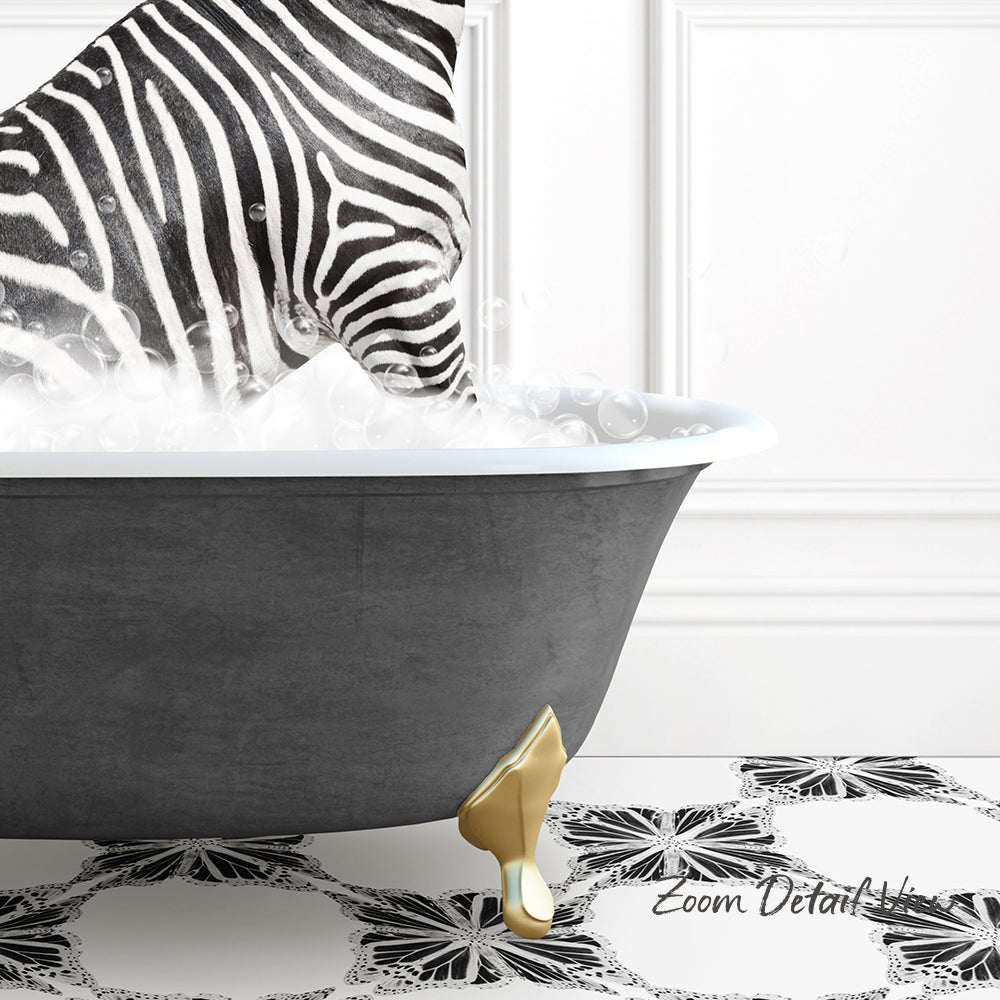 A zebra standing in a bathtub filled with bubbles, with a gold bathtub leg visible.