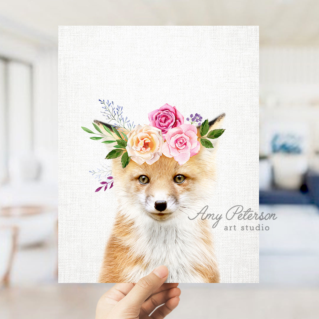 a hand holding up a card with a picture of a fox wearing a flower crown