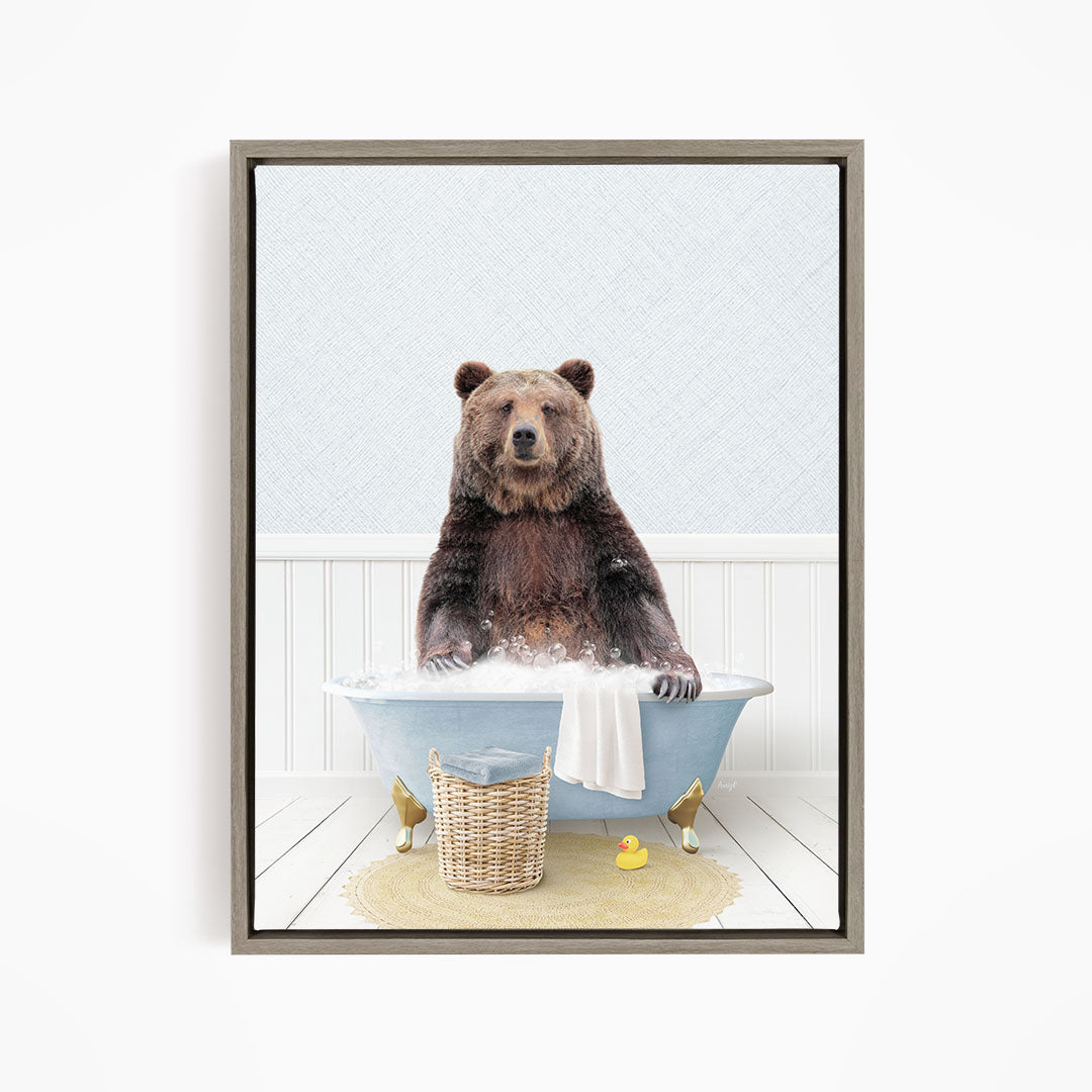 A brown bear sitting in a blue bathtub filled with water, surrounded by a yellow rubber duck and a basket.