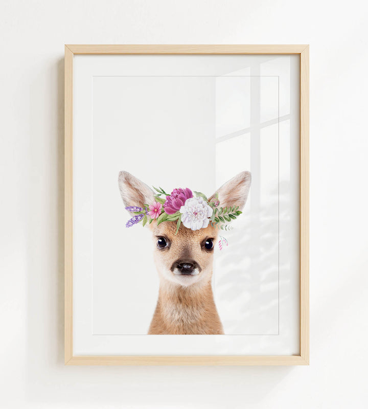 A deer wearing a floral crown on its head is the central focus of the framed print.