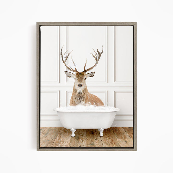 A deer with large antlers is sitting in a white bathtub filled with water, creating a whimsical and unexpected scene.