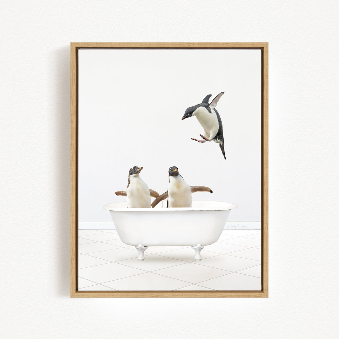 A framed image depicting two penguins sitting in a bathtub, with one penguin flying towards the other.