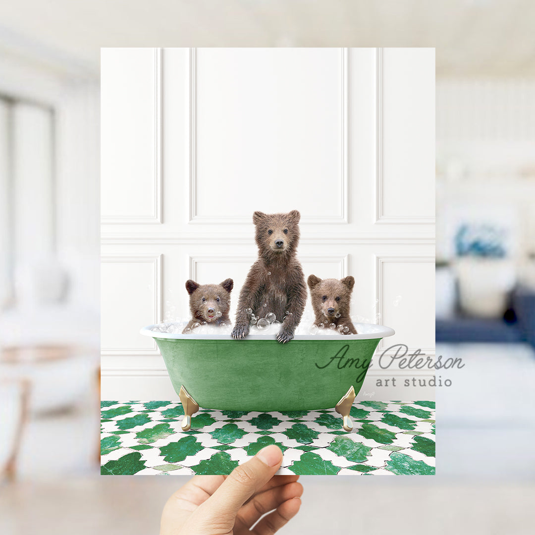 a hand holding a card with three bears in a bathtub