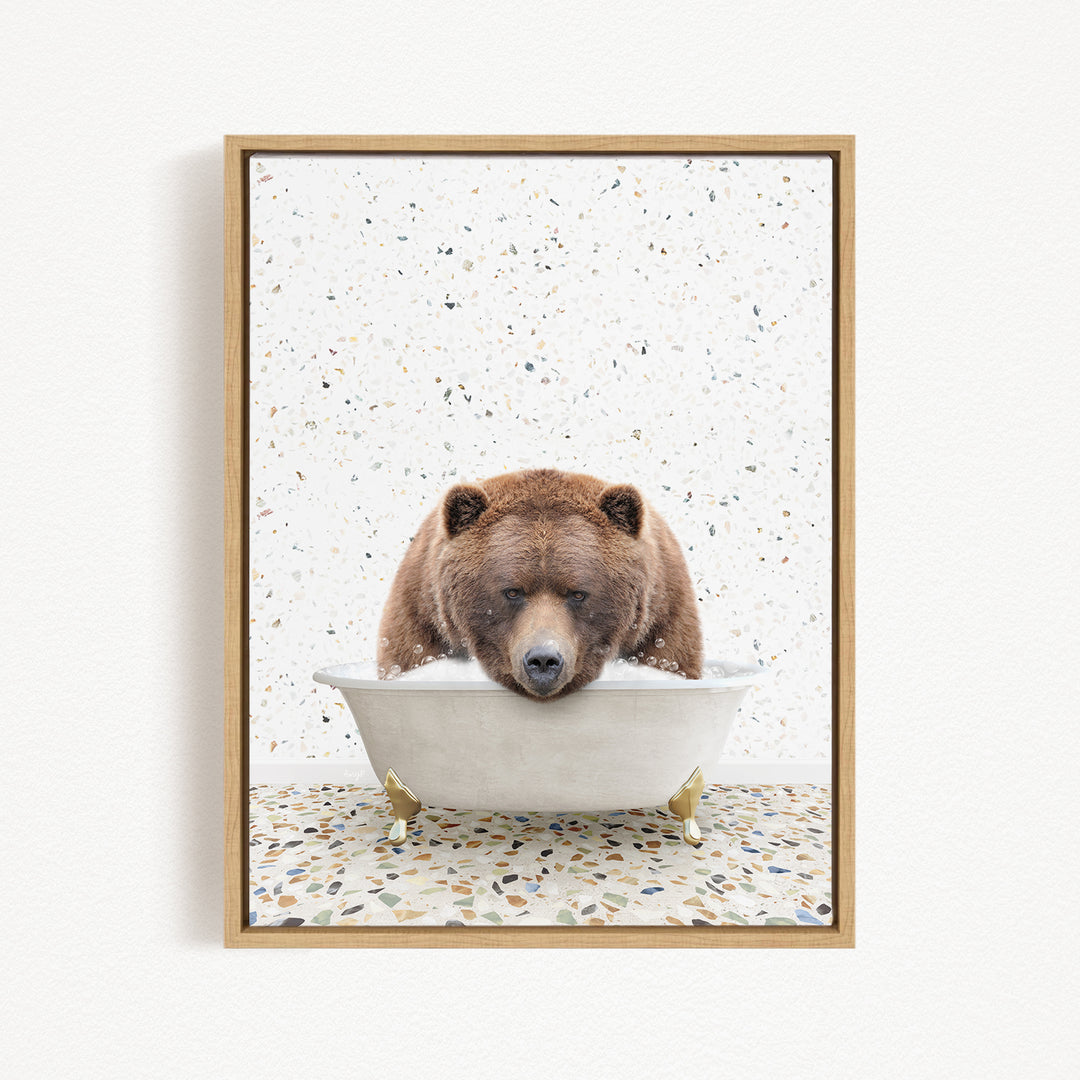 A brown bear is sitting in a white bathtub, appearing to be enjoying a relaxing bath.