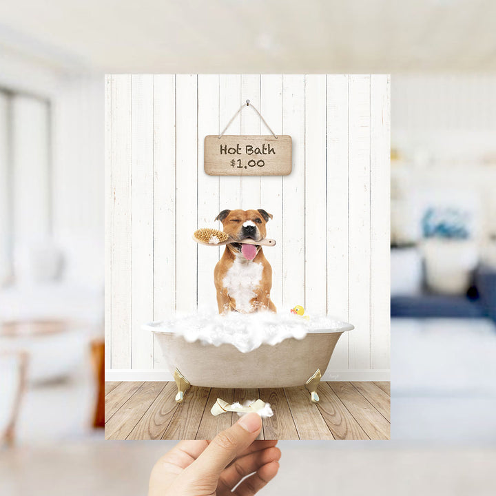 A brown and white dog sitting in a bathtub filled with bubbles, holding a brush in its mouth, with a sign that says "Hot Bath $1.00" above it.