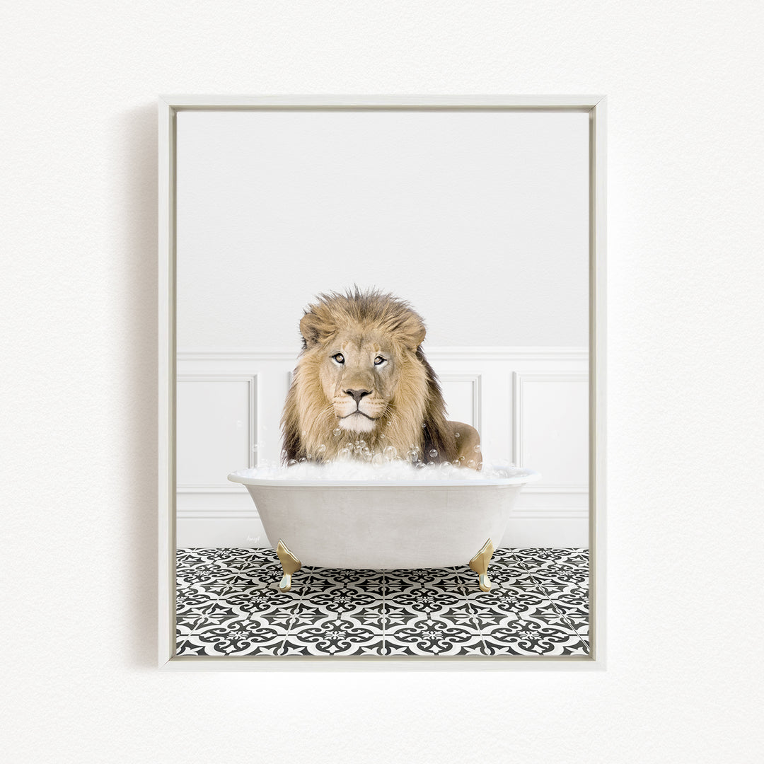 A lion sitting in a white bathtub filled with bubbles, looking directly at the camera.