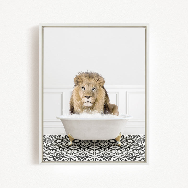 A lion sitting in a white bathtub filled with bubbles, looking directly at the camera.