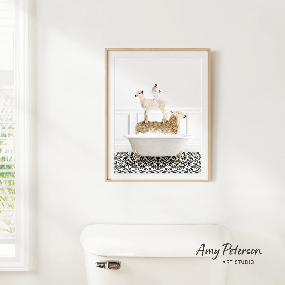 A framed image of a sheep standing on a bathtub in a bathroom, with a window and toilet visible in the background.