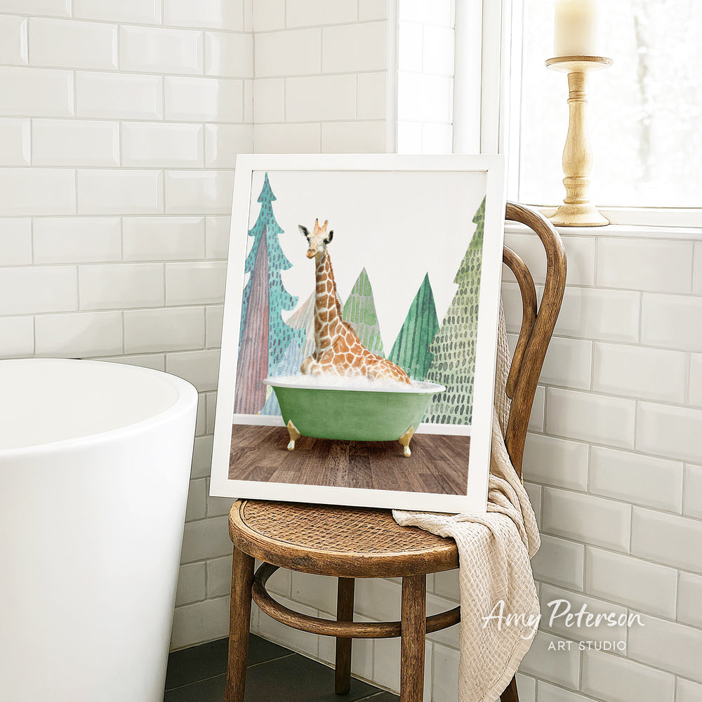 A framed painting of a giraffe sitting in a green bathtub, surrounded by trees, is displayed on a wooden chair in a bathroom setting.