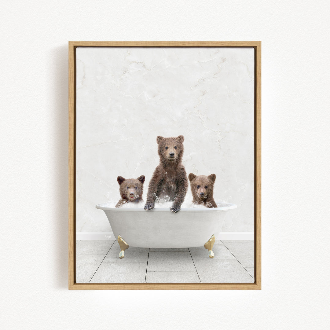 A framed image depicting three brown bears sitting in a white bathtub, with one bear sitting at the center and the other two bears sitting on either side.
