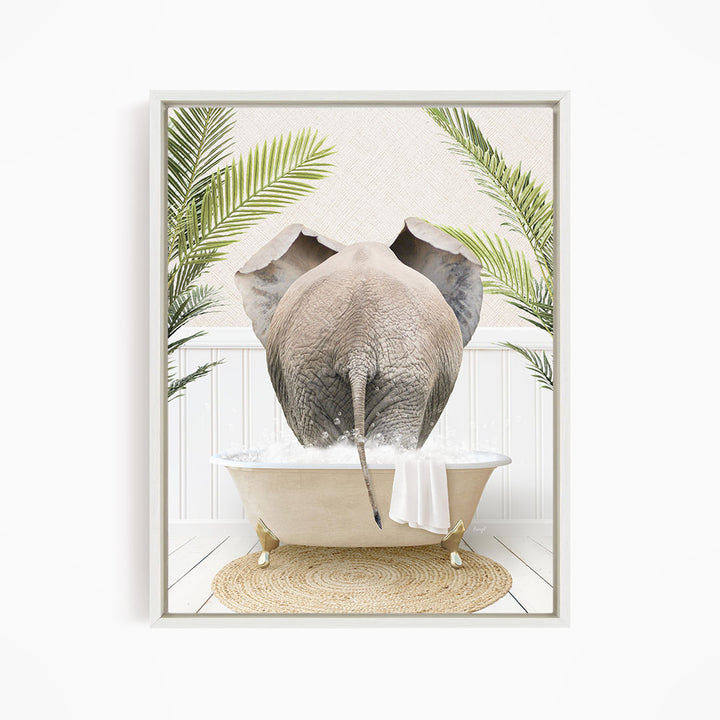 A gray elephant is sitting in a white bathtub filled with water, surrounded by green palm leaves and a woven mat on the floor.