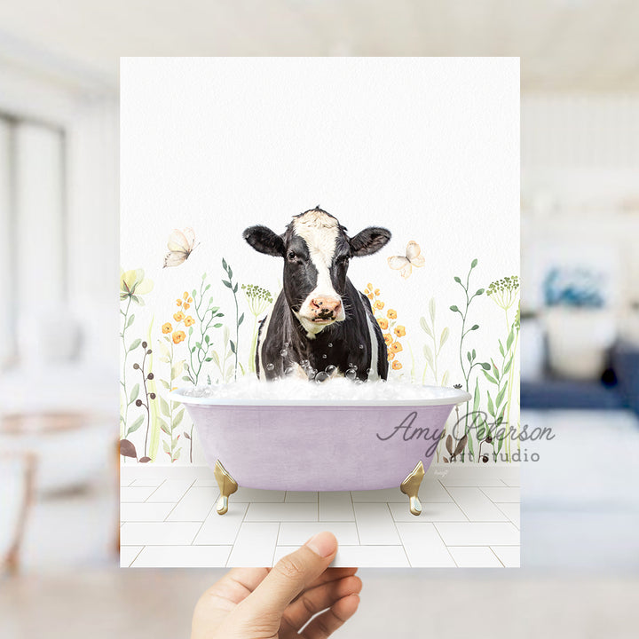 a person holding up a card with a picture of a cow in a bathtub