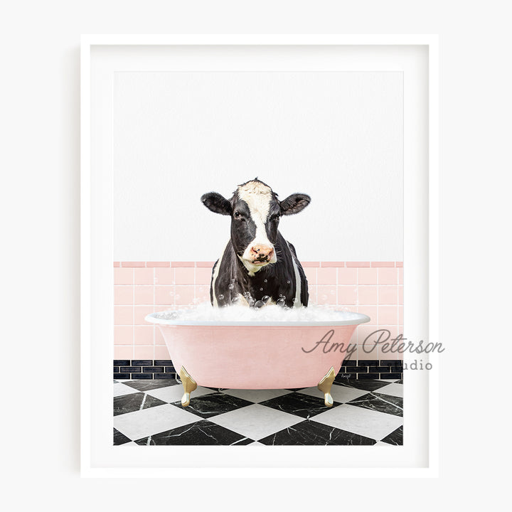 a black and white cow in a pink bathtub