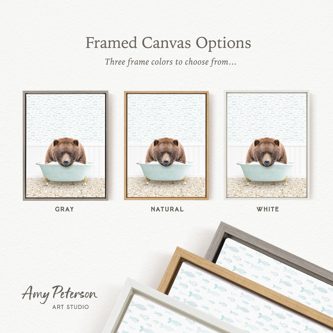 three framed canvas options, each featuring a brown bear sitting in a bathtub. The options include a gray frame, a natural frame, and a white frame.