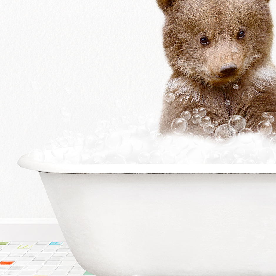 a brown bear sitting in a bathtub filled with bubbles