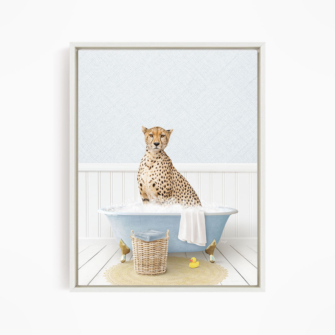 A cheetah sitting in a blue bathtub filled with water, surrounded by a yellow rubber duck and a wicker basket.