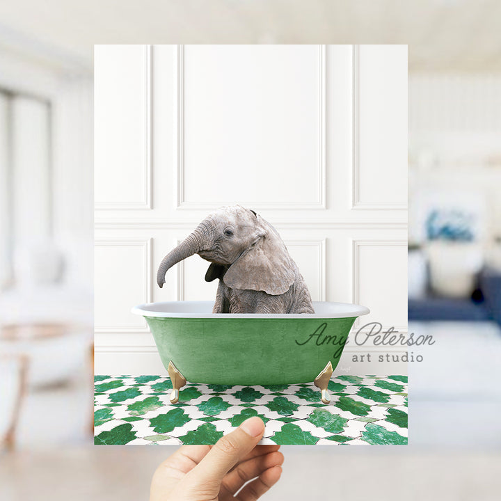 a hand holding a card with an elephant in a bathtub