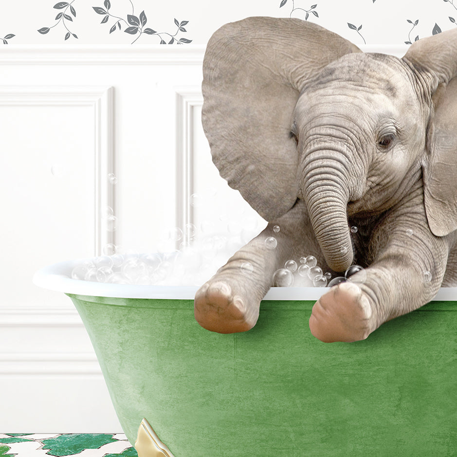 a baby elephant taking a bath in a green tub