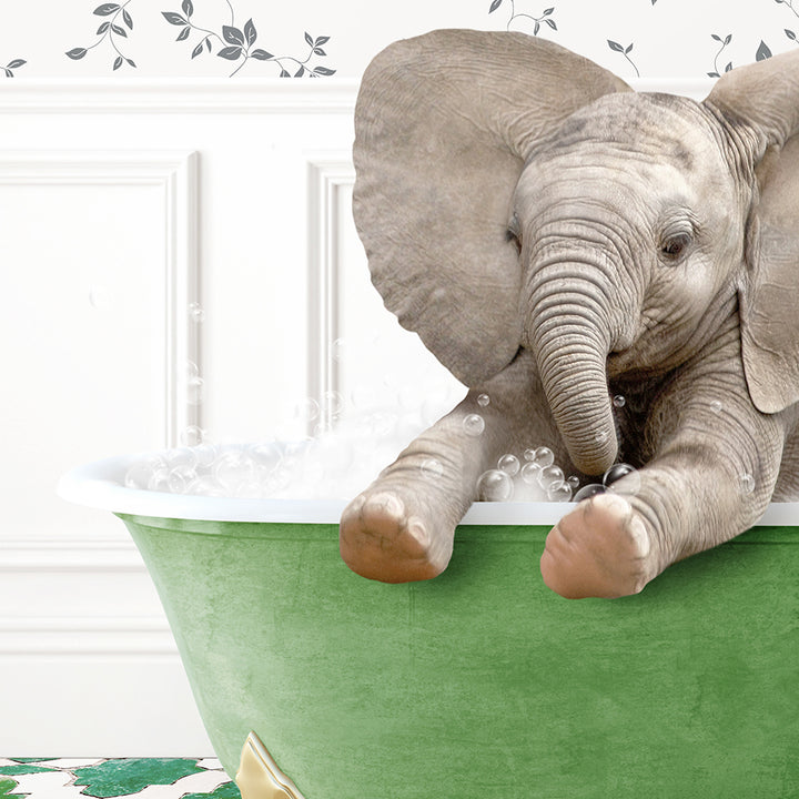 a baby elephant taking a bath in a green tub