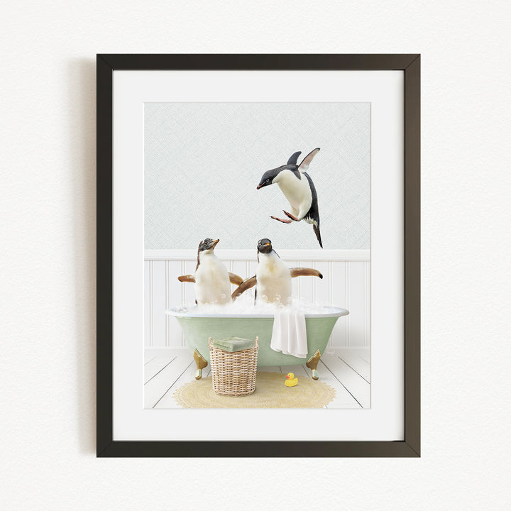 A framed image depicting two penguins sitting in a bathtub, with one penguin flying towards the other penguin.