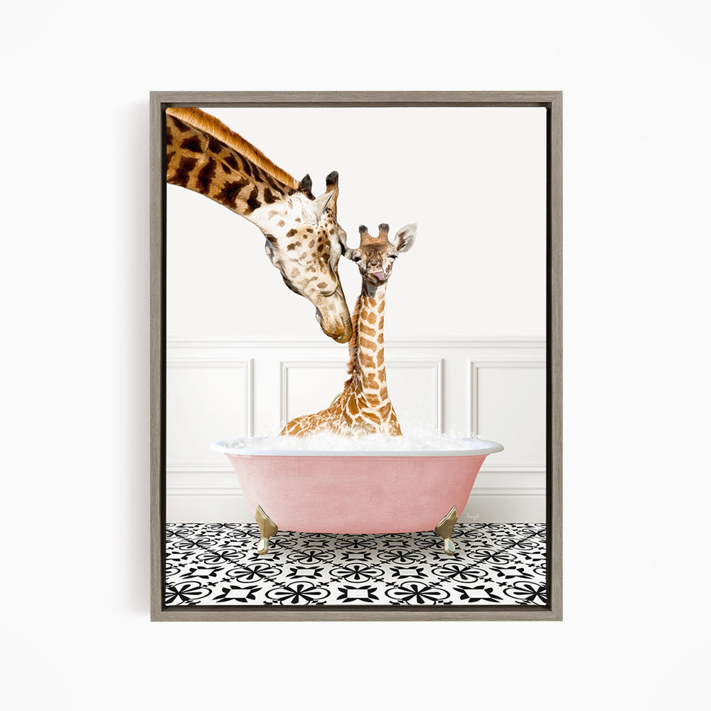 A mother giraffe and her baby giraffe are sitting together in a pink bathtub, with the mother gently licking her baby.