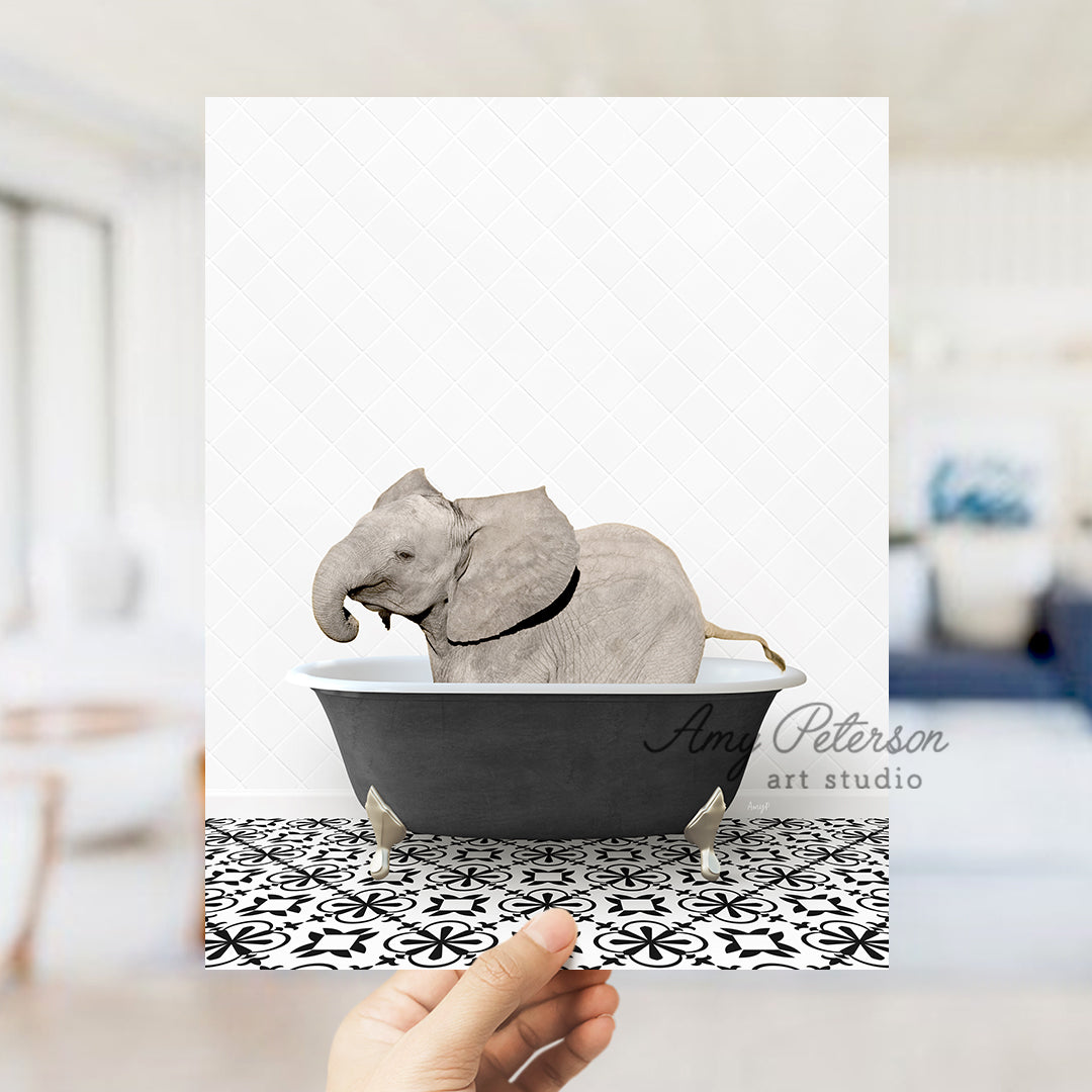 a person holding up a card with an elephant in a bathtub