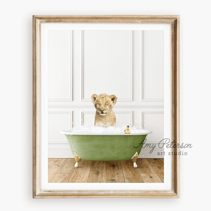 a framed photograph of a baby lion in a bathtub