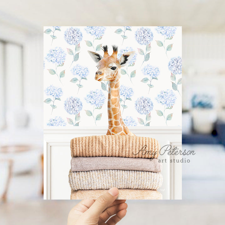 a giraffe standing on top of a pile of towels