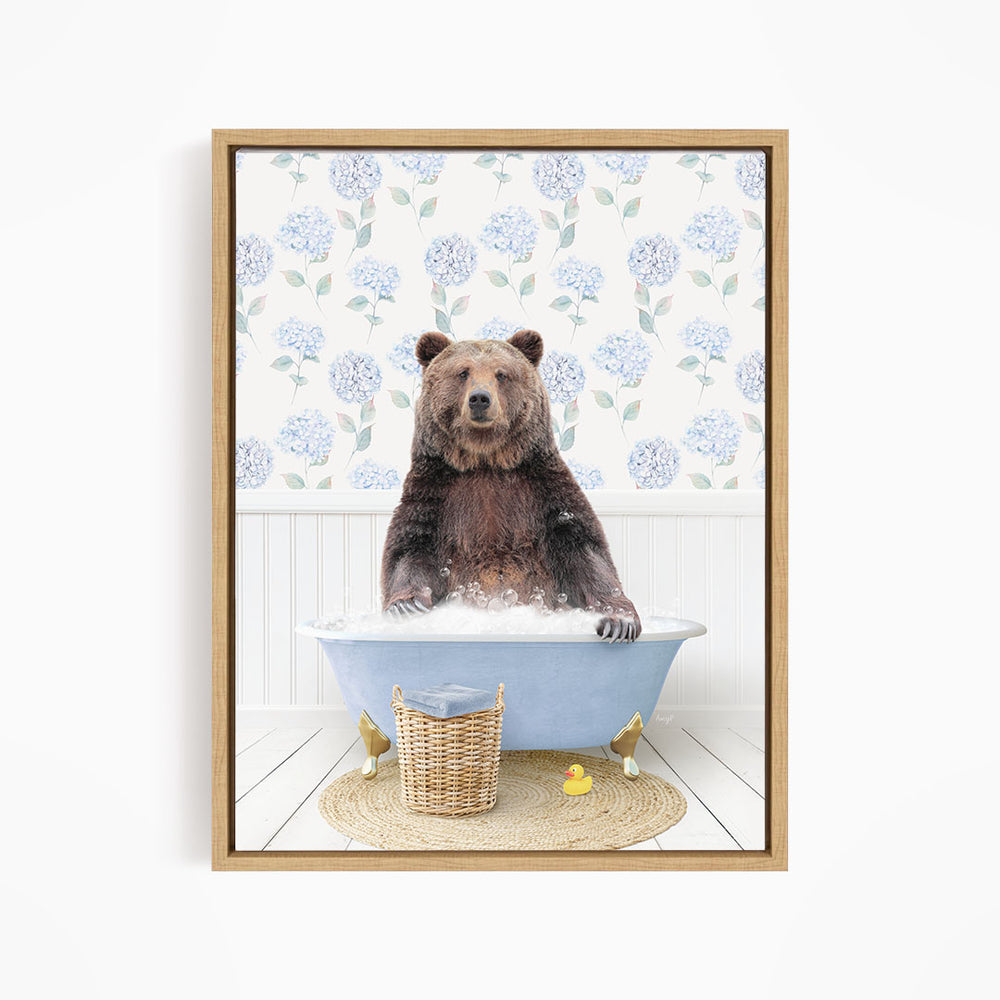 A brown bear sitting in a blue bathtub filled with water, surrounded by a wicker basket and rubber duckies.