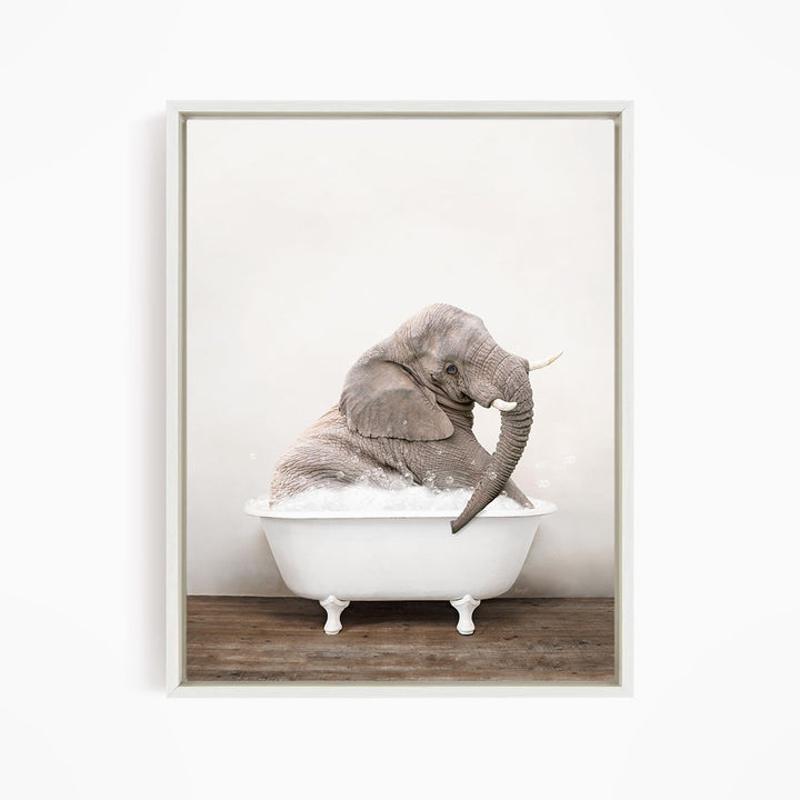 A gray elephant sitting in a white bathtub filled with water, with its trunk raised.