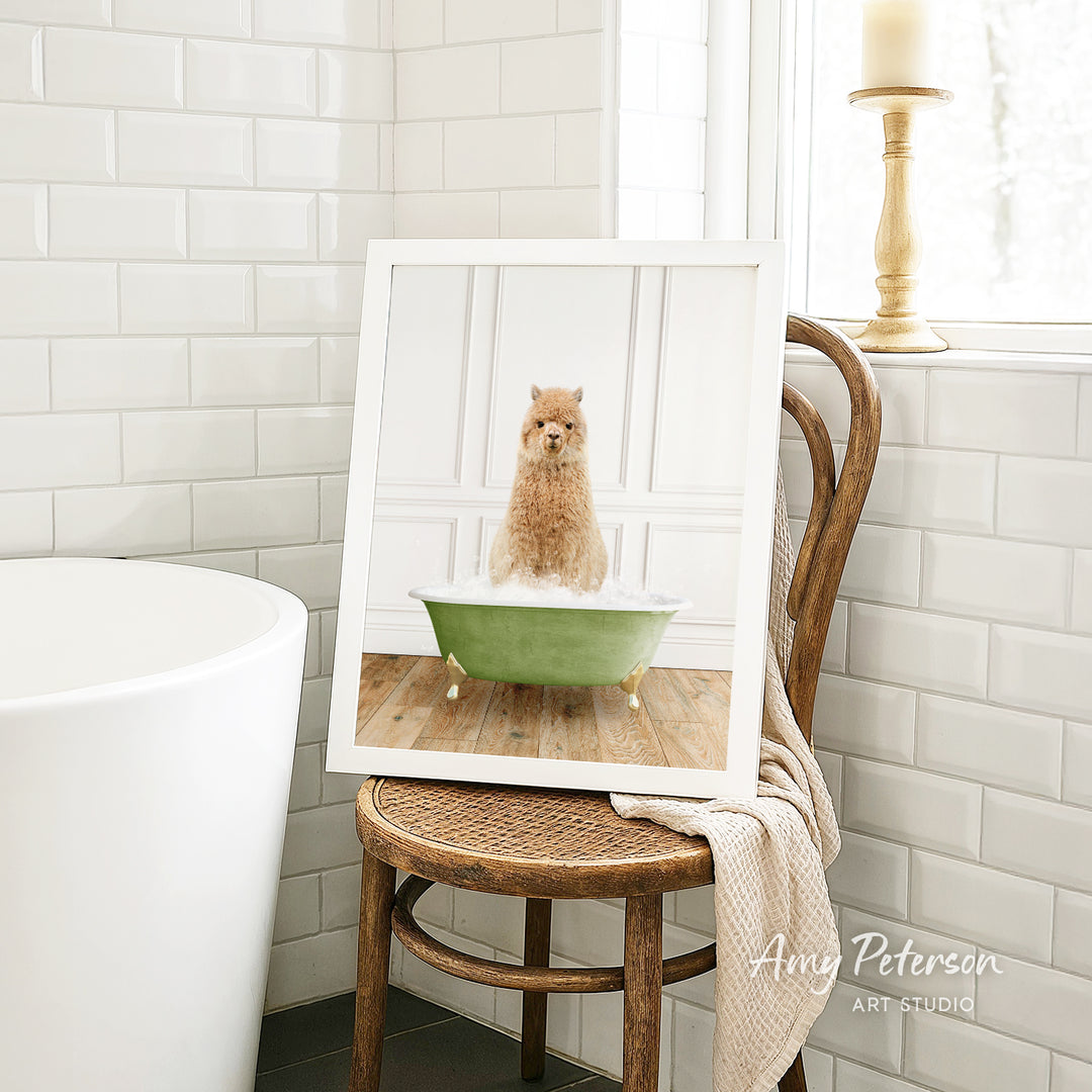 A framed image of a small dog sitting in a green bathtub, surrounded by white tiles and a wooden chair.