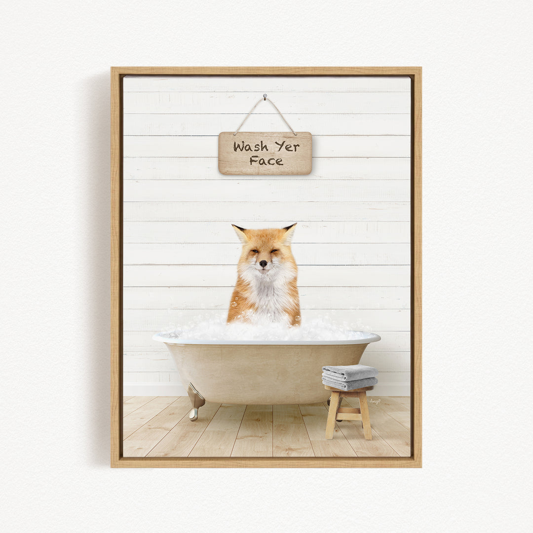 A framed image depicting a cat sitting in a bathtub filled with water, with a sign above that reads "Wash Yer Face".