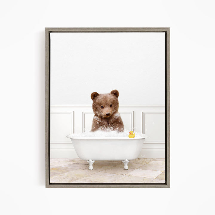 A brown bear sitting in a white bathtub filled with water, with a rubber duck floating nearby.