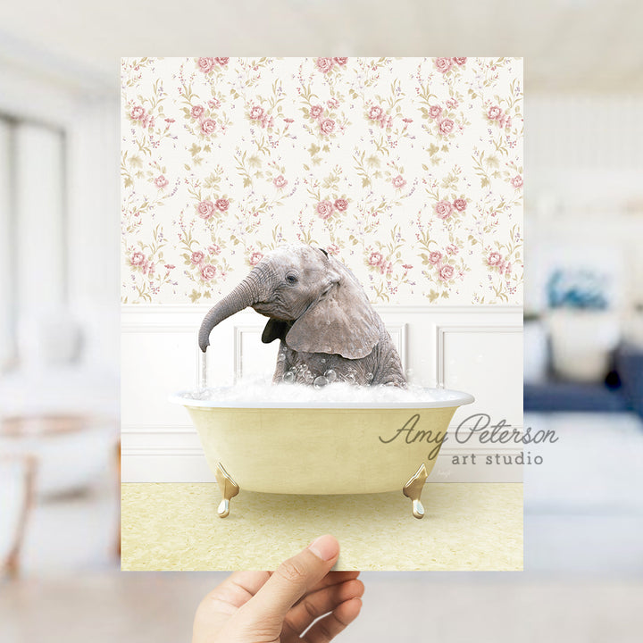 a person holding up a picture of an elephant in a bathtub