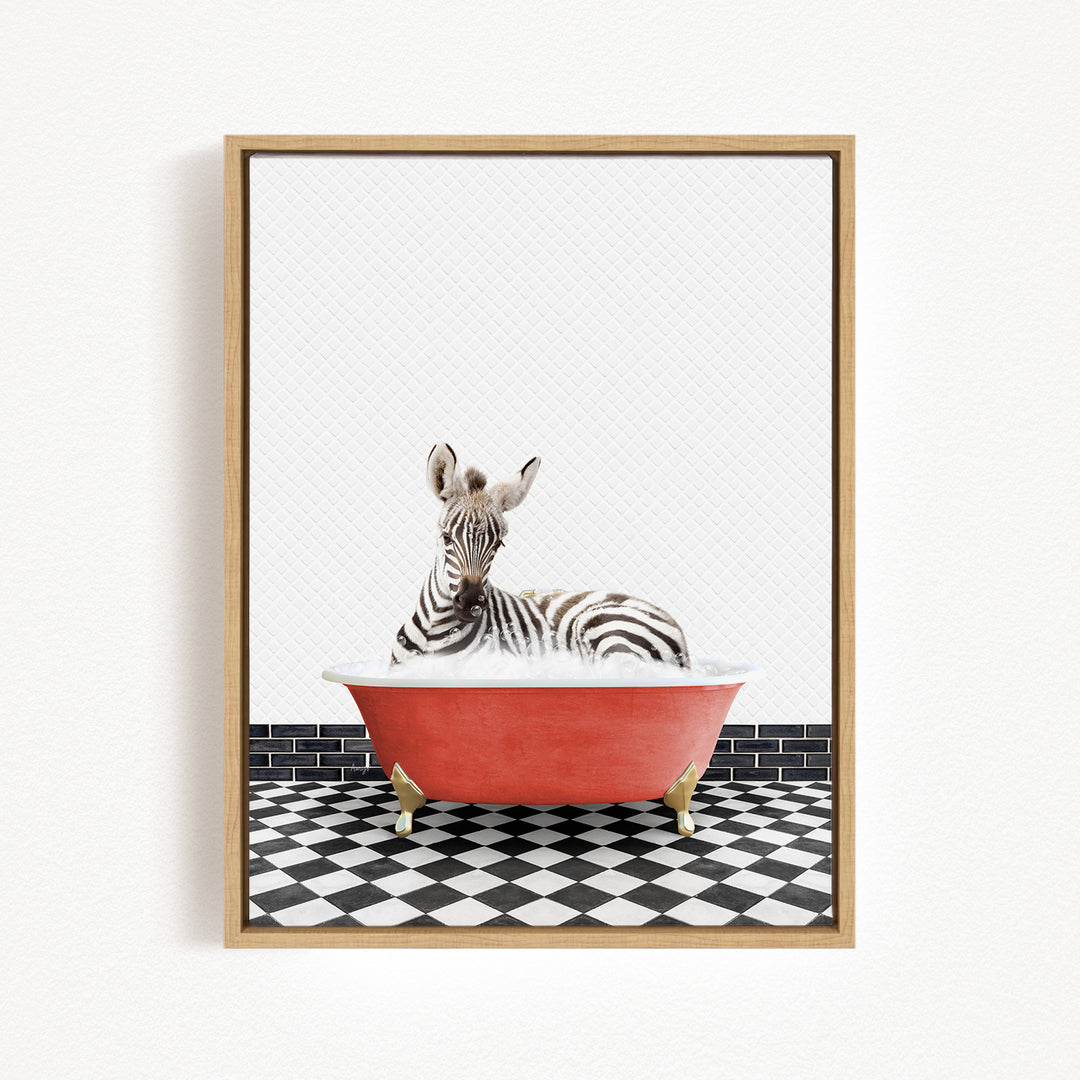 A zebra is sitting in a red bathtub on a black and white checkered floor.