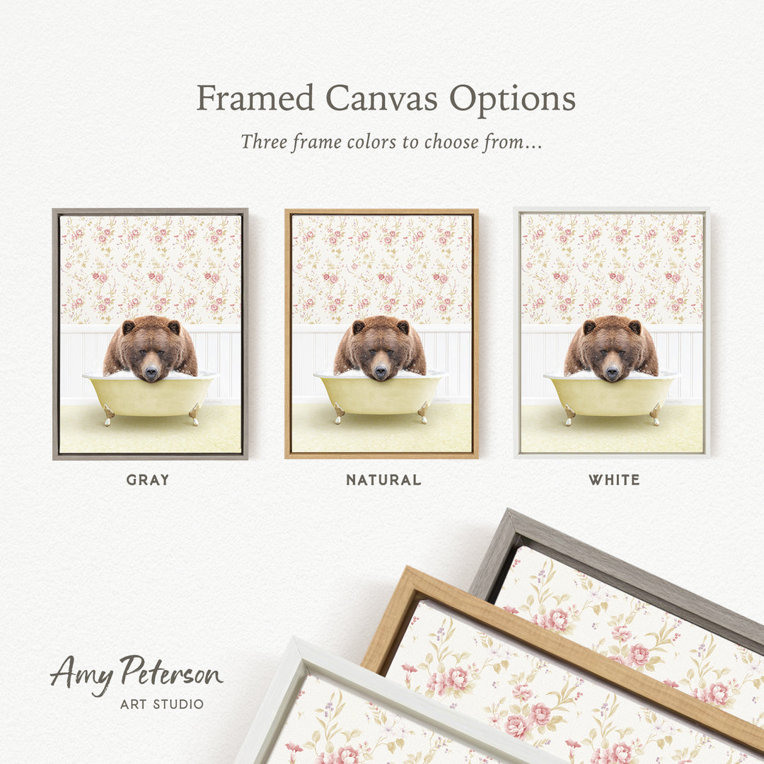 The image is a framed canvas option featuring three different framed pictures of a brown bear sitting in a bathtub, each with a different frame color: gray, natural, and white.