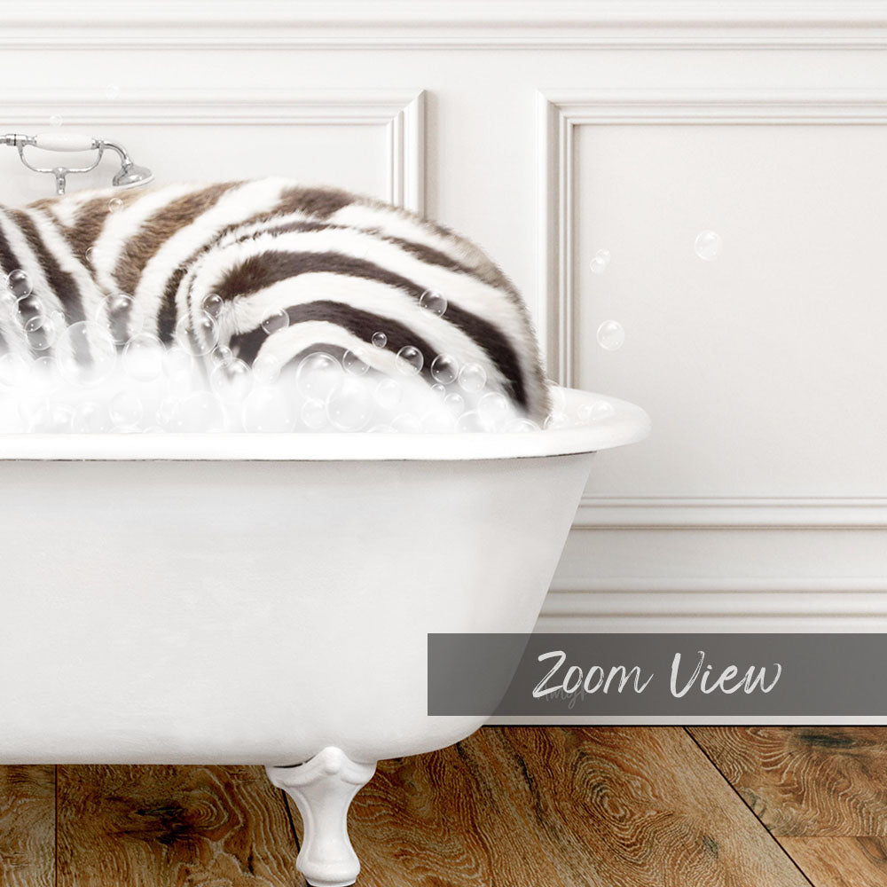 A zebra lying in a bathtub filled with bubbles, as seen in a close-up view.