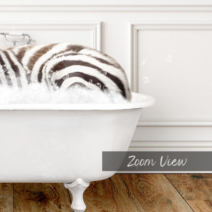 A zebra lying in a bathtub filled with bubbles, as seen in a close-up view.