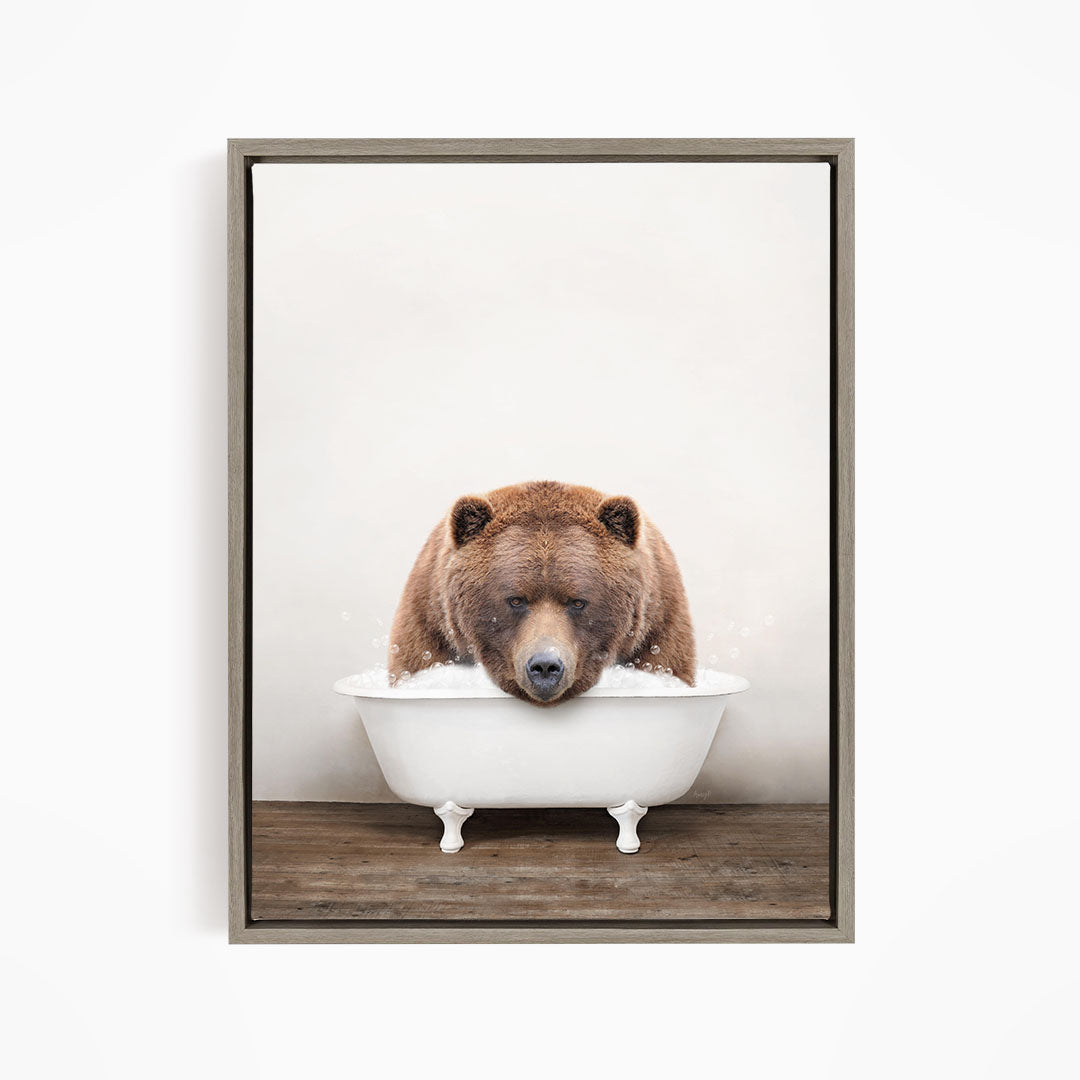 A brown bear sitting in a white bathtub, appearing to be enjoying a relaxing bath.